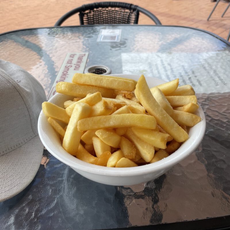 A bowl of chips resting on a glass table cooling down.